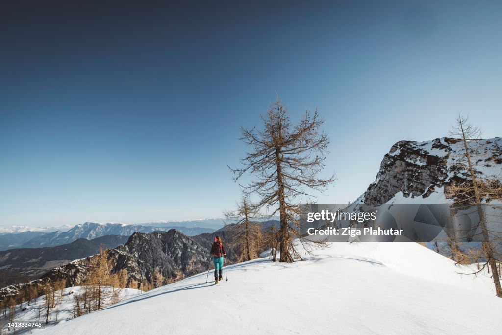 Hiking for the view - Woman hiker on a winter hike