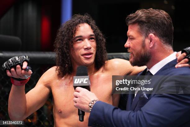 Bryan Battle is interviewed by Michael Bisping after his victory over Takashi Sato of Japan in a welterweight fight during the UFC Fight Night event...