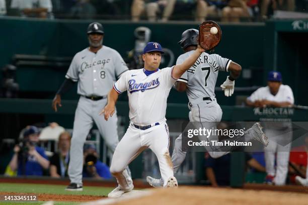 Nathaniel Lowe of the Texas Rangers makes the catch for the out at first base against Tim Anderson of the Chicago White Sox in the ninth inning at...