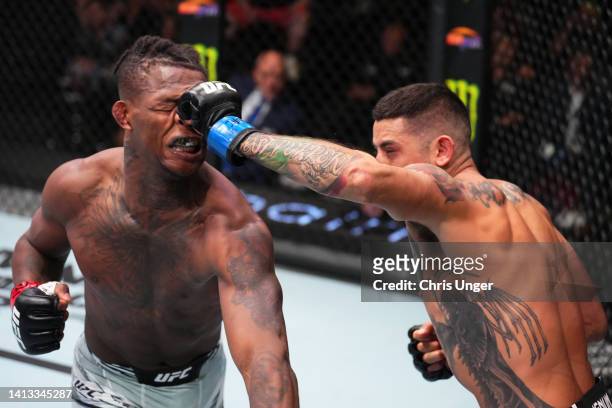 Erick Gonzalez punches Terrance McKinney in a lightweight fight during the UFC Fight Night event at UFC APEX on August 06, 2022 in Las Vegas, Nevada.