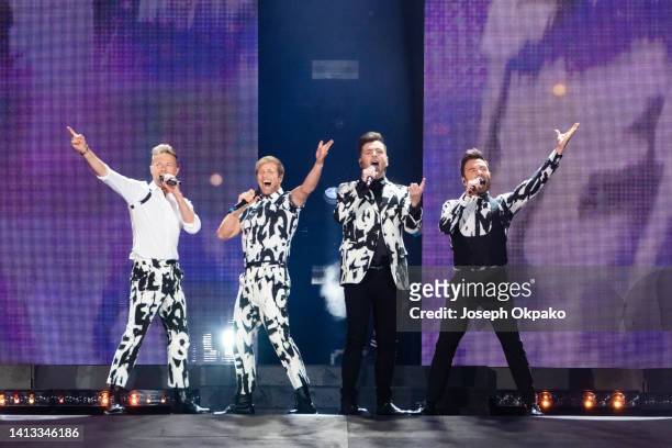 Nicky Byrne, Kian Egan, Markus Feehily and Shane Filan of Westlife Perform at Wembley Stadium on August 06, 2022 in London, England.