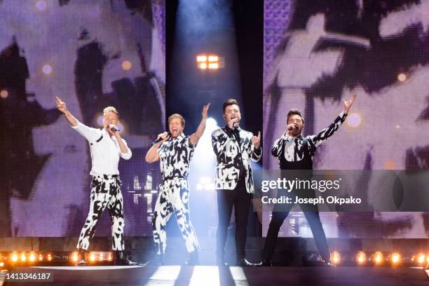 Nicky Byrne, Kian Egan, Markus Feehily and Shane Filan of Westlife Perform at Wembley Stadium on August 06, 2022 in London, England.