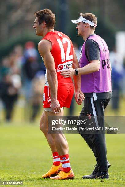 Josh P. Kennedy of the Swans leaves the field injured during the round 20 VFL match between North Melbourne Kangaroos and Sydney Swans at Arden...