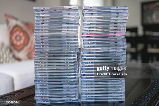 cds stacked on coffee table - dvd photos et images de collection