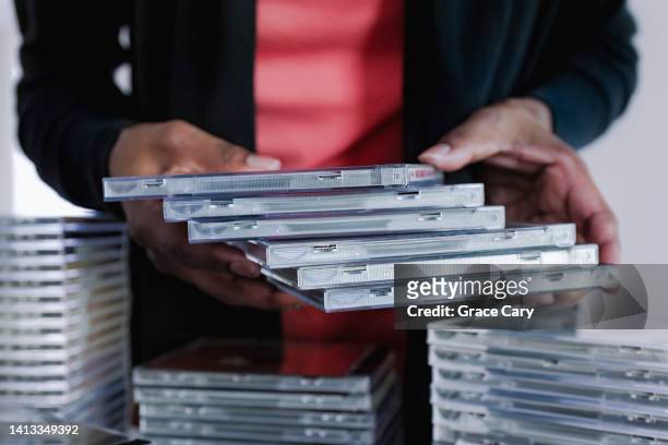 woman sorts her cd collection - rom stock pictures, royalty-free photos & images