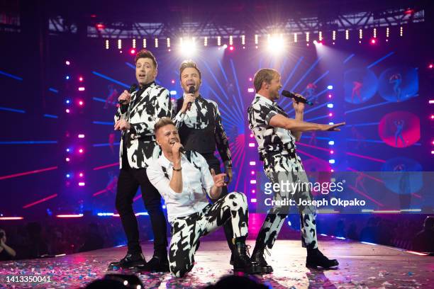 Markus Feehily, Nicky Byrne, Shane Filan and Kian Egan of Westlife Perform at Wembley Stadium on August 06, 2022 in London, England.