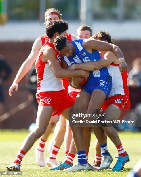 Aiden Bonar of the Kangaroos is tackled during the round 20 VFL match between North Melbourne Kangaroos and Sydney Swans at Arden Street Ground on...