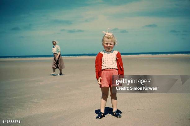 child and grandmother on beach - blonde girl smiling stock-fotos und bilder