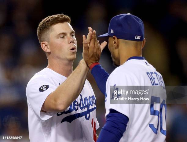Will Smith of the Los Angeles Dodgers and Mookie Betts of the Los Angeles Dodgers celebrate an 8-3 win over the San Diego Padres at Dodger Stadium on...