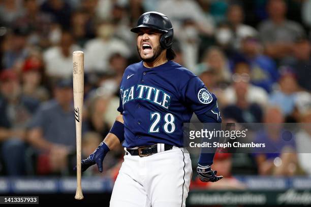 Eugenio Suarez of the Seattle Mariners reacts after getting hit by a pitch in the hand during the eighth inning against the Los Angeles Angels at...