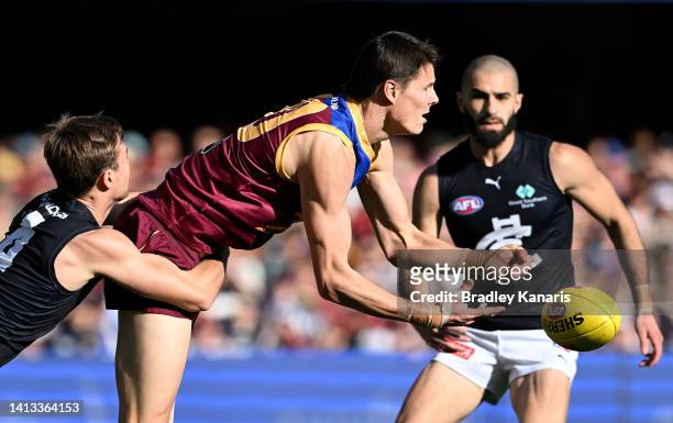 Eric Hipwood of the Lions gets a handball away during the round 21 AFL match between the Brisbane Lions and the Carlton Blues at The Gabba on August...