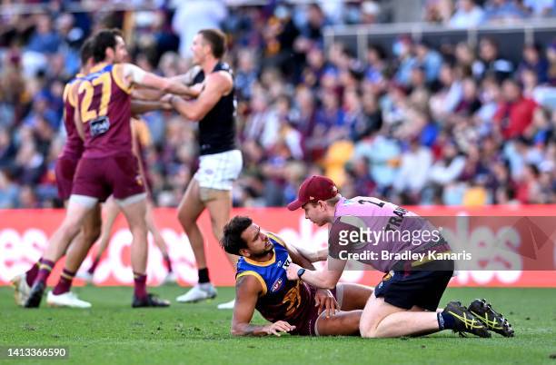 Callum Ah Chee of the Lions is injured during the round 21 AFL match between the Brisbane Lions and the Carlton Blues at The Gabba on August 07, 2022...