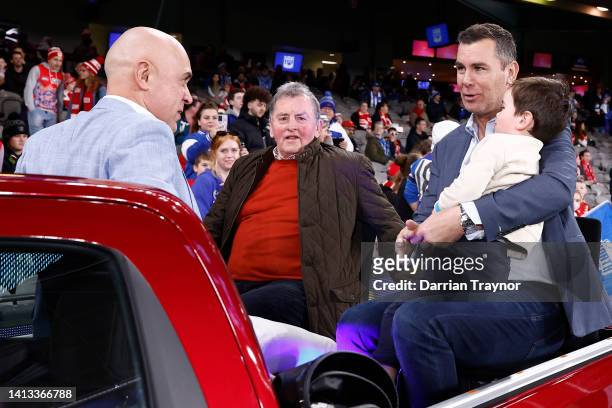 North Melbourne Premiership players Wayne Schwass and Wayne Carey are seen with coach Denis Pagan before the round 21 AFL match between the North...