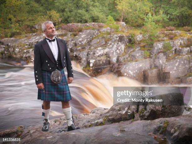 man standing by river in prince charlie outfit with douglas modern tartan - kilt bildbanksfoton och bilder