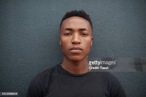 portrait of serious isolated young man face, head and thinking. confident, assured and assertive male posing and expressing his identity. closeup of guy standing against a wall copy space background. - male model casual imagens e fotografias de stock