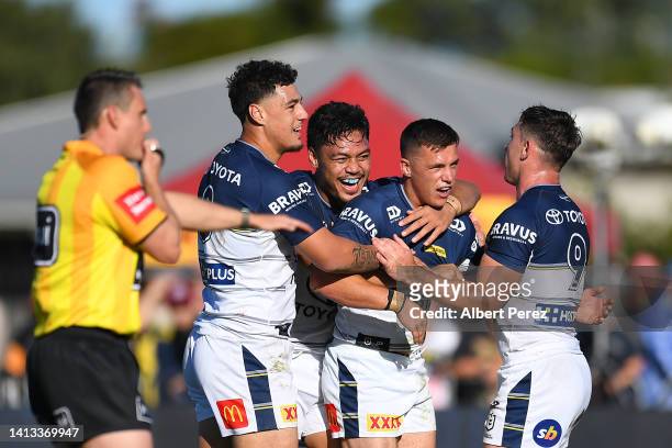 Scott Drinkwater of the Cowboys celebrates with team mates after scoring a try during the round 21 NRL match between the Canterbury Bulldogs and the...