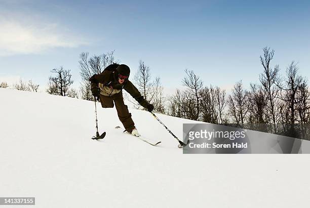 One-legged skier snowy slope