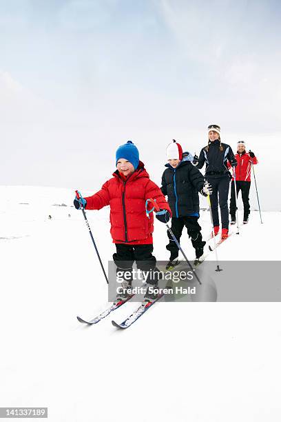 family cross country skiing in snow - geilo stock pictures, royalty-free photos & images