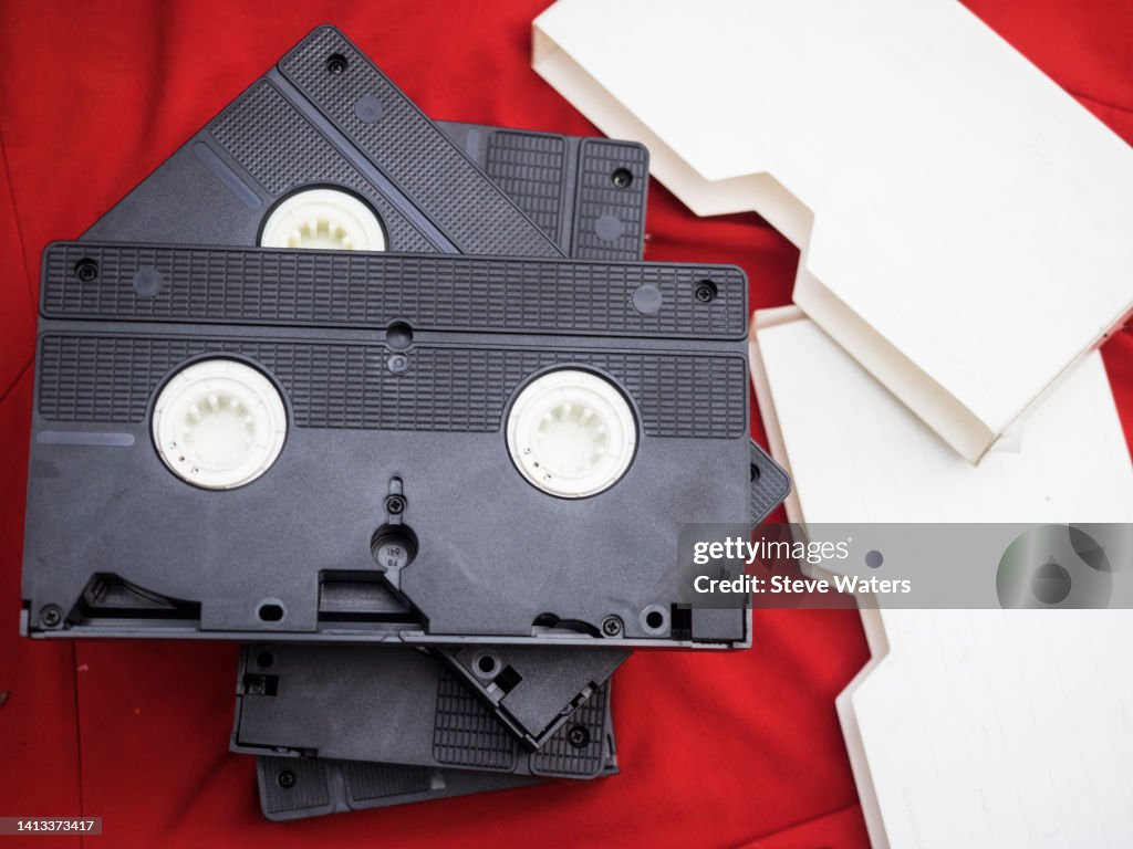 Stack Of 4 Vhs Cassettes On A Red Background With White Sleeves High ...