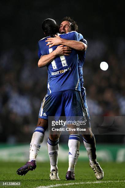 Didier Drogba and Frank Lampard of Chelsea celebrate their team's victory after the final whistle during the UEFA Champions League round of 16 second...