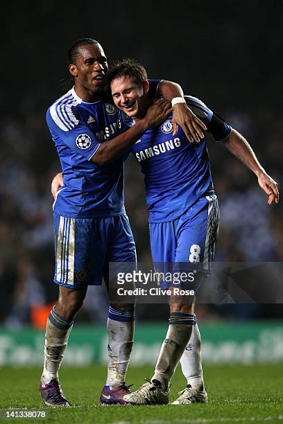 Didier Drogba and Frank Lampard of Chelsea celebrate their team's victory after the final whistle during the UEFA Champions League round of 16 second...