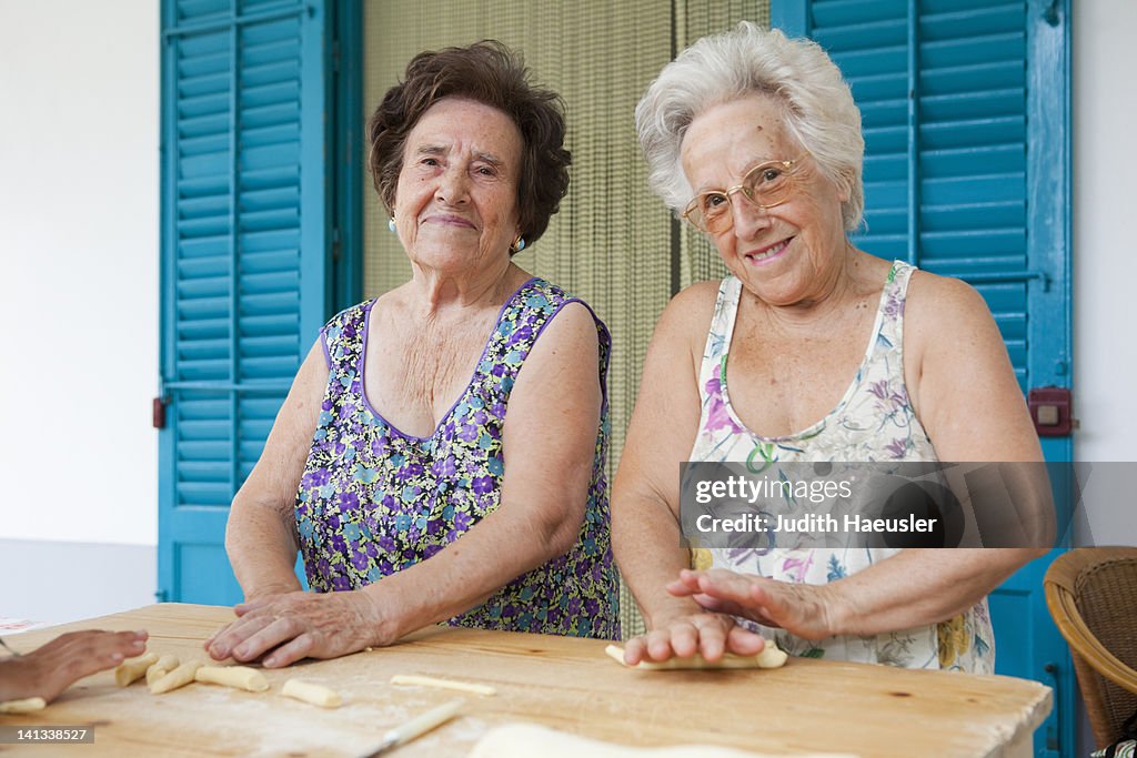 Older women making pasta together