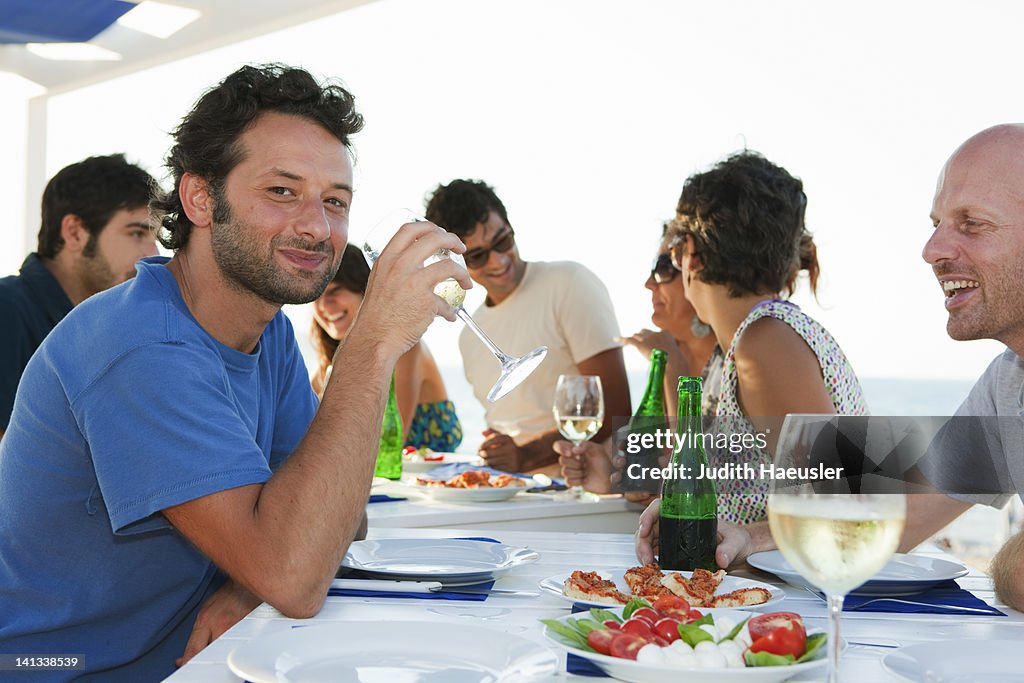 Friends drinking at table outdoors