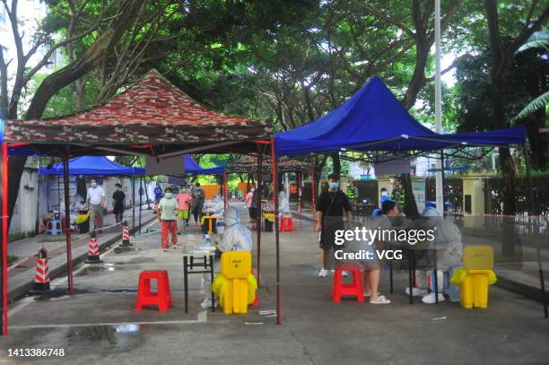 People queue up for COVID-19 nucleic acid tests on August 7, 2022 in Sanya, Hainan Province of China.