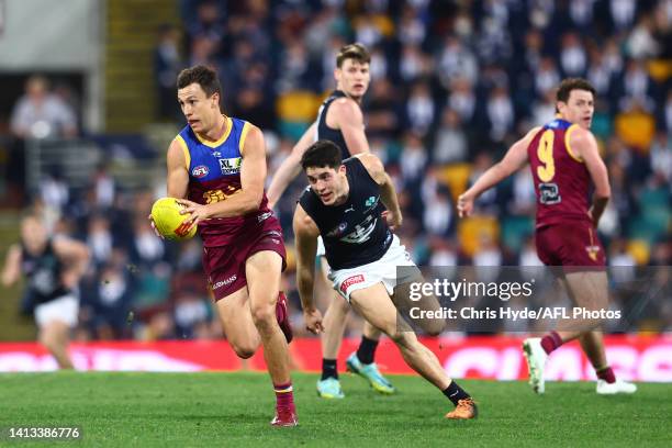 Hugh McCluggage of the Lions runs the ball during the round 21 AFL match between the Brisbane Lions and the Carlton Blues at The Gabba on August 07,...