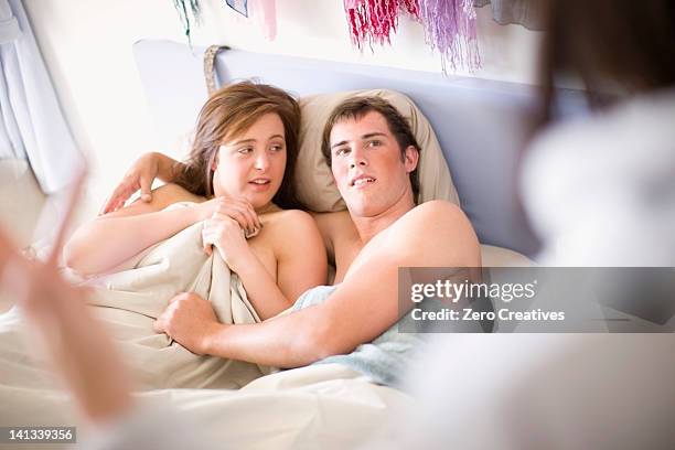 woman walking in on nude teenage couple - three people in bed stock pictures, royalty-free photos & images