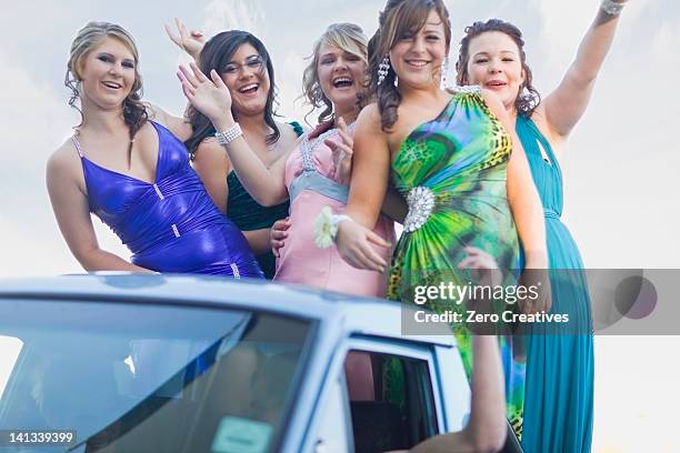 teenage girls in gowns waving from car - prom stock pictures, royalty-free photos & images