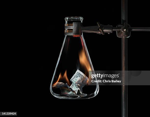 money burning in beaker - glass beaker stock pictures, royalty-free photos & images