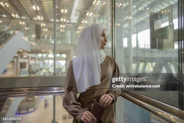 businesswoman at the airport for business trip - islamic finance stock pictures, royalty-free photos & images