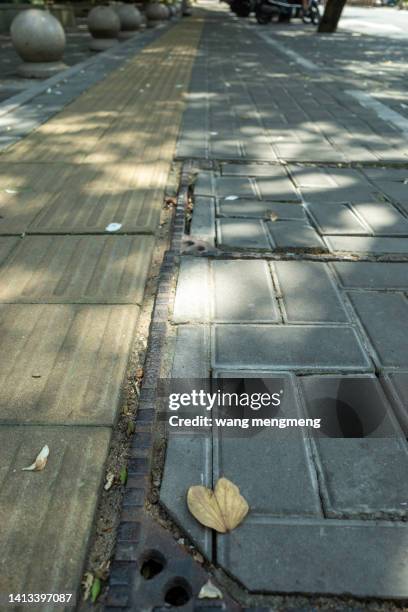floor tiles and blind lanes on the sidewalk - tile kiln stock pictures, royalty-free photos & images