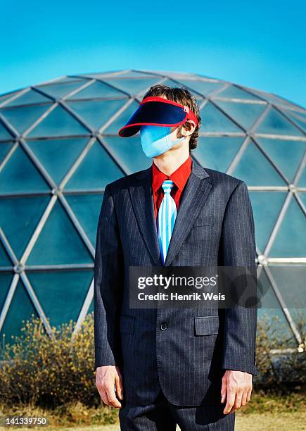businessman wearing visor and mask - hypochondria - fotografias e filmes do acervo