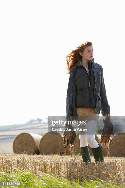 teenage girl carrying game birds - galliformes stock pictures, royalty-free photos & images