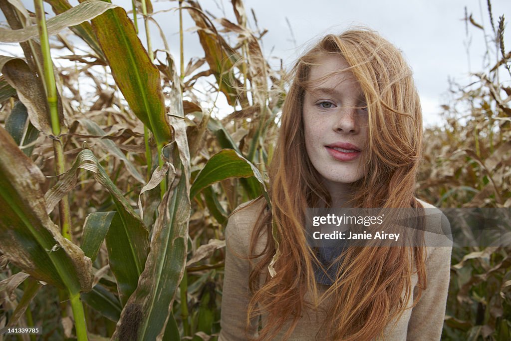 Teenage girl walking in cornfield