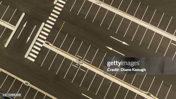 aerial view of empty spaces in a car park - road marking stock pictures, royalty-free photos & images