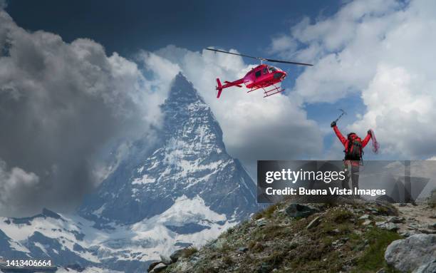 climber waiting for rescue by helicopter - military helicopter stock-fotos und bilder