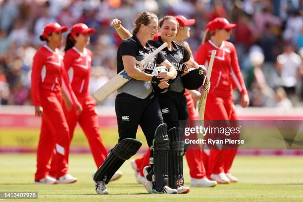 Sophie Devine and Amelia Kerr of Team New Zealand celebrate after their innings during the Cricket T20 - Bronze Medal match between Team England and...