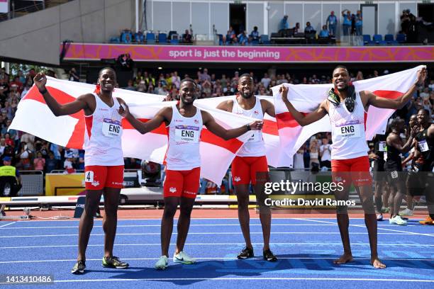 Ojie Edoburun, Jona Efoloko, Nethaneel Mitchell-Blake and Zharnel Hughes of Team England celebrate winning the gold medal in the Men's 4 x 100m Relay...