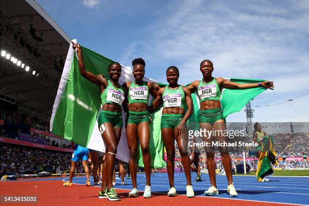 Tobi Amusan, Favour Ofili, Rosemary Chukwuma and Nzubechi Grace Nwokocha of Team Nigeria celebrate winning the gold medal in the Women's 4 x 100m...