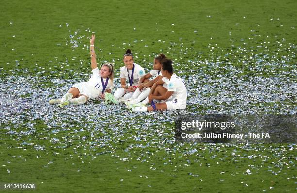 Lauren Hemp, Lucy Bronze, Demi Stokes and Nikita Parris of England celebrate following the UEFA Women's Euro 2022 final match between England and...