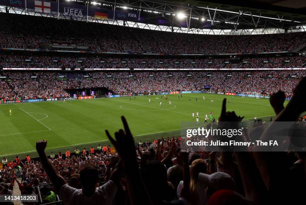 Fans celebrate England's victory at full time following the UEFA Women's Euro 2022 final match between England and Germany at Wembley Stadium on July...