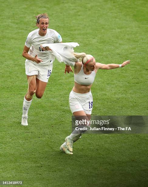 Chloe Kelly of England takes her shirt off to celebrate with teammate Jill Scott after scoring their team's second goal during the UEFA Women's Euro...