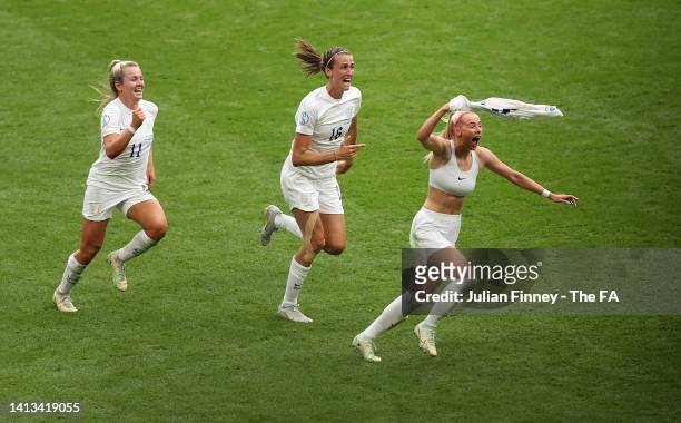 Chloe Kelly of England celebrates with teammates Jill Scott and Lauren Hemp after scoring their team's second goal during the UEFA Women's Euro 2022...