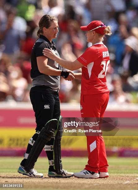 Katherine Brunt of Team England speaks to Sophie Devine of Team New Zealand following the Cricket T20 - Bronze Medal match between Team England and...