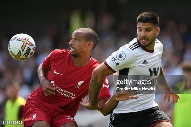 Joel Matip of Liverpool is challenged by Aleksandar Mitrovic of Fulham during the Premier League match between Fulham FC and Liverpool FC at Craven...