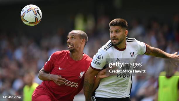 Joel Matip of Liverpool is challenged by Aleksandar Mitrovic of Fulham during the Premier League match between Fulham FC and Liverpool FC at Craven...