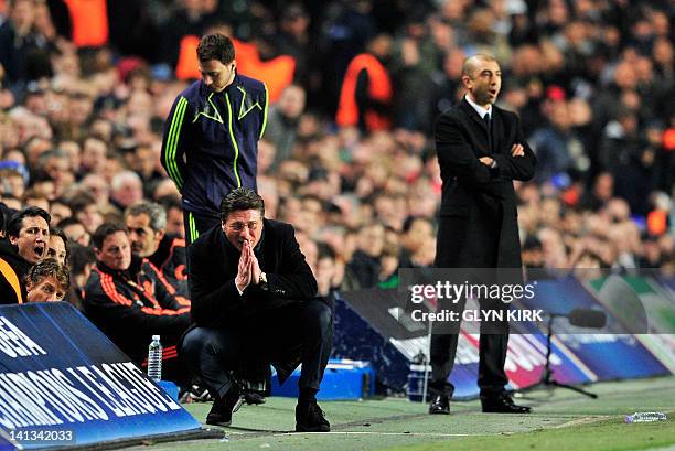 Napoli's manager Walter Mazzarri prays during their UEFA Champions League round of 16 second leg football match against Chelsea at Stamford Bridge,...